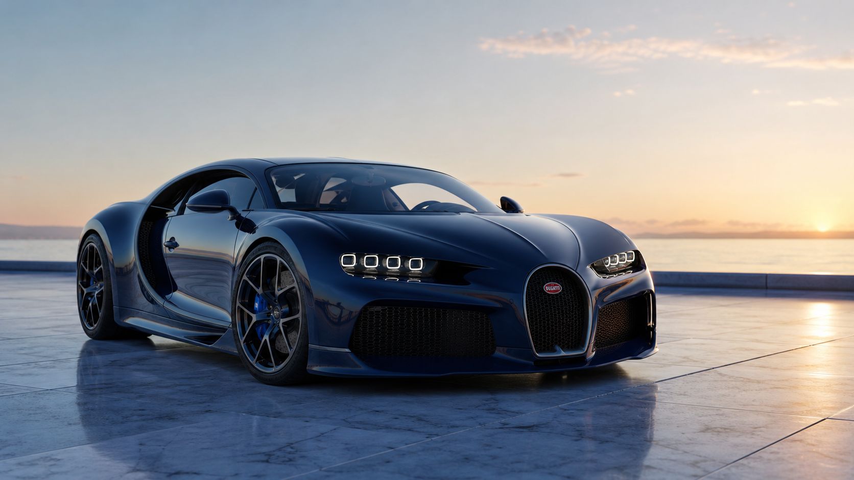A sleek dark blue Bugatti Chiron sports car parked on a marble terrace overlooking the ocean at sunset.